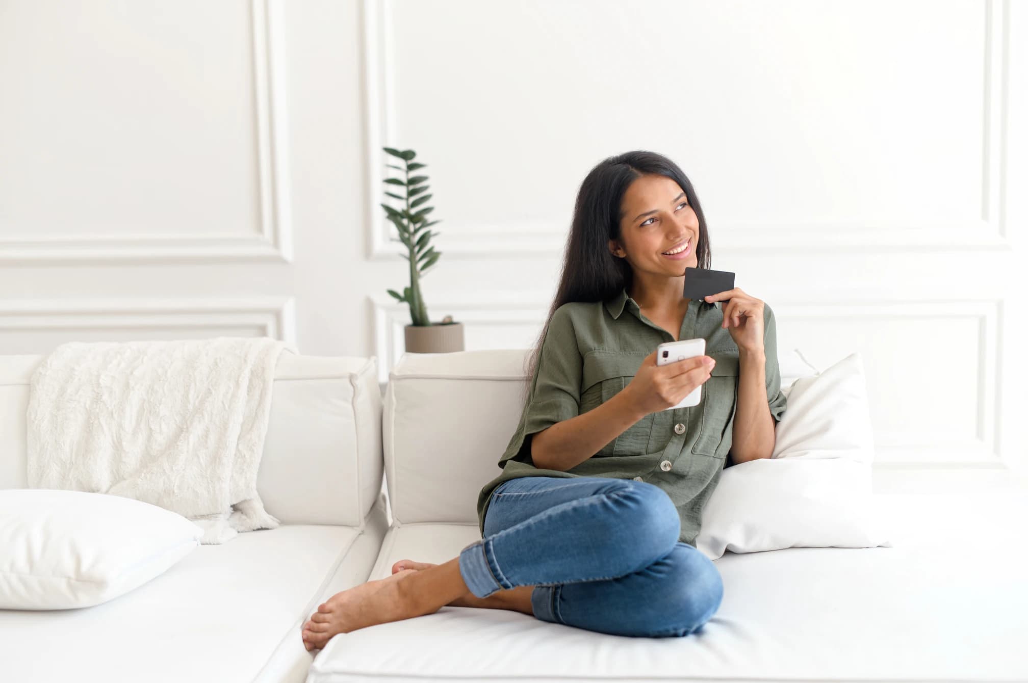 Woman holding credit card and smartphone