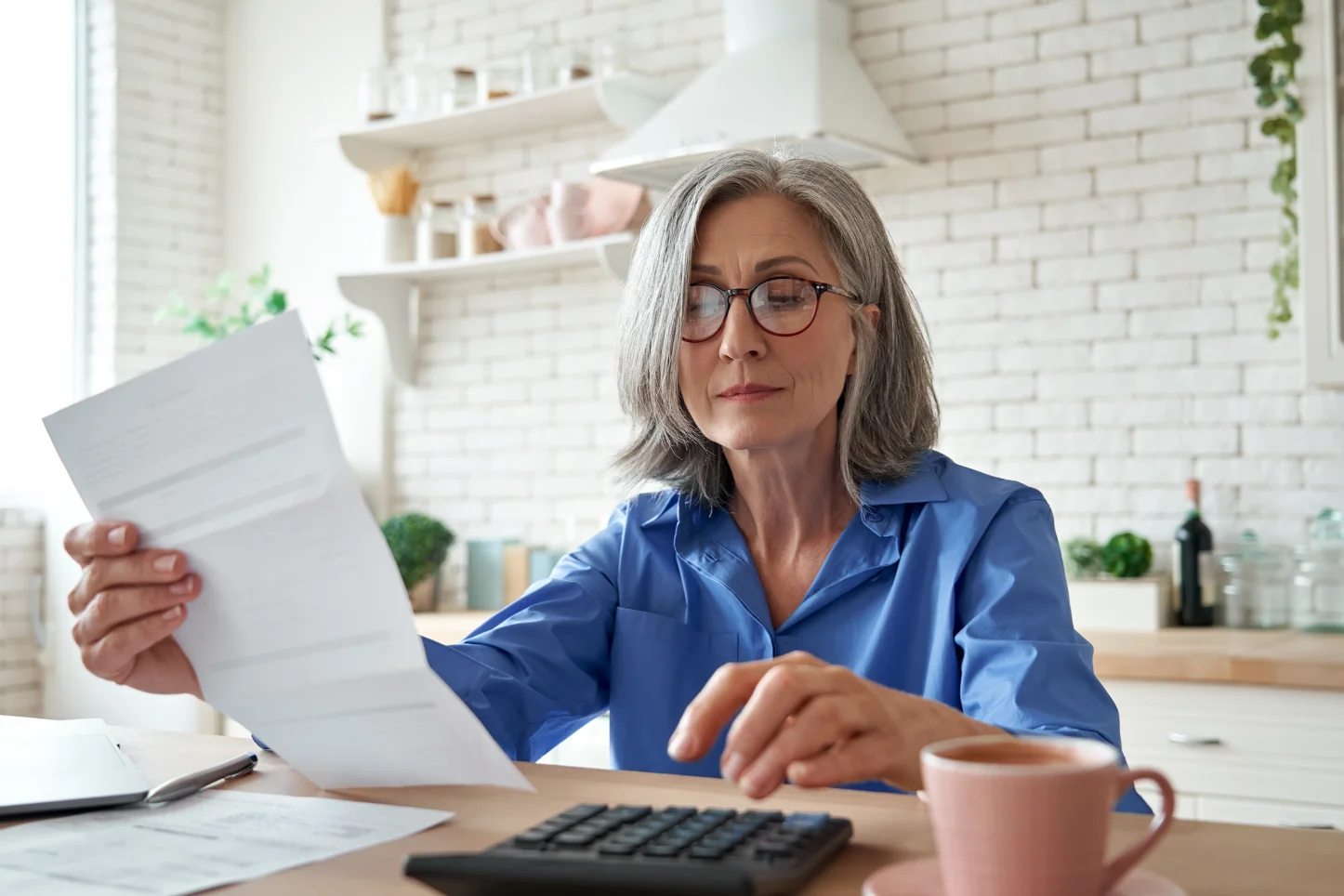 retiree-analyzing-annuity-paperwork-and-pension-documents-with-calculator