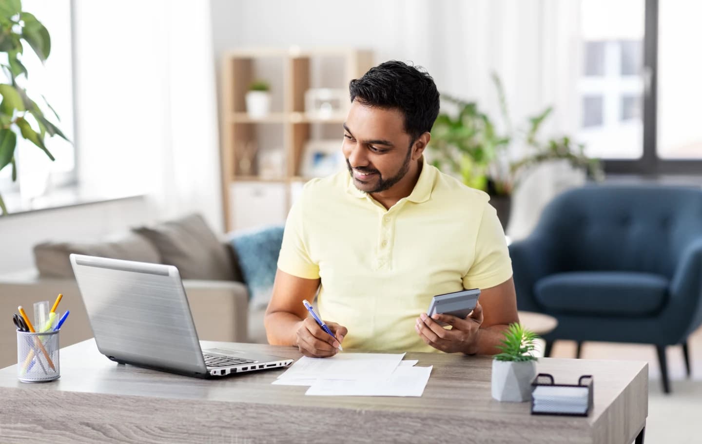 canadian-filling-out-tax-return-form-with-calculator-and-receipts