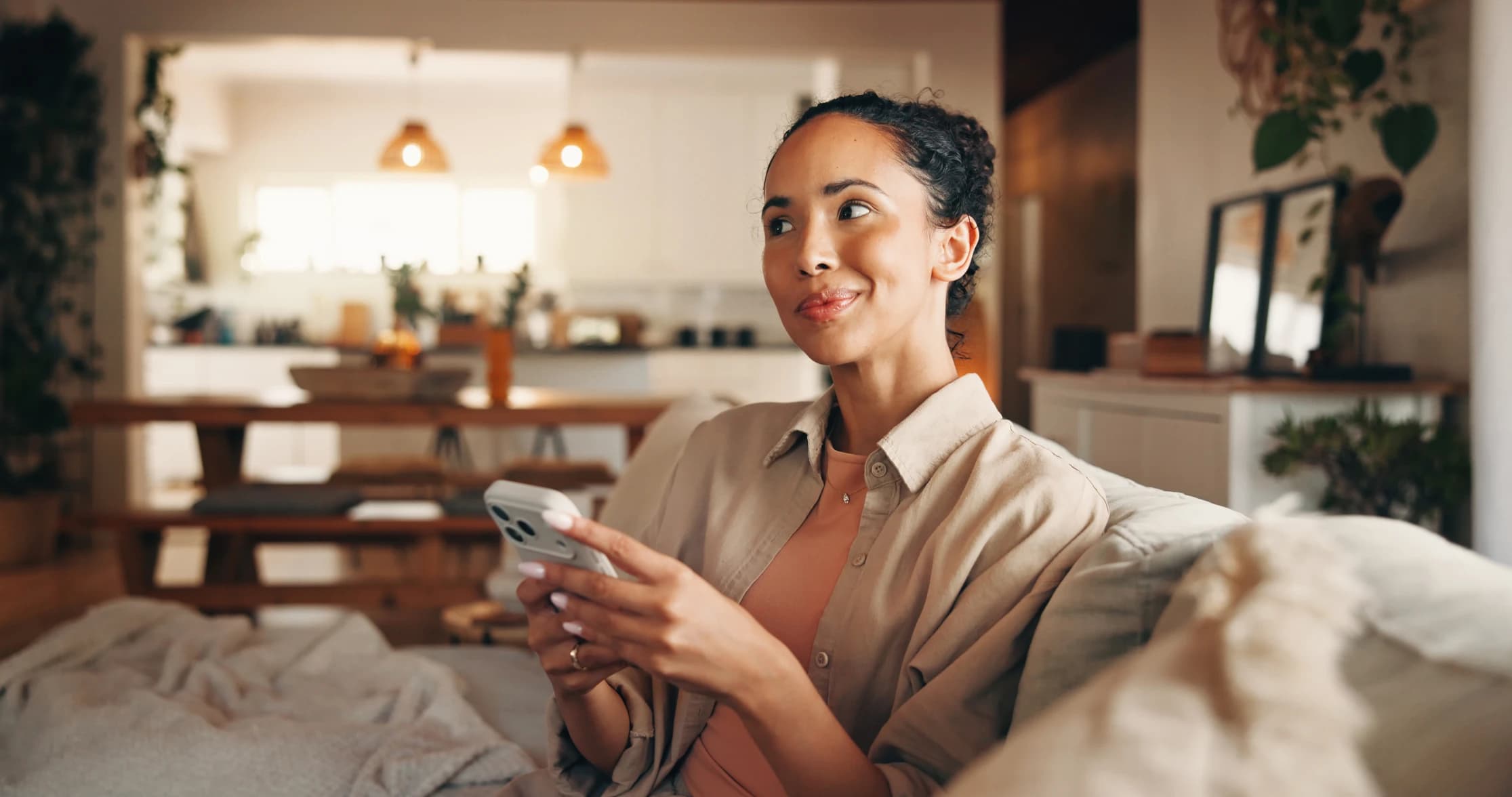Woman thinking on sofa in living room of home