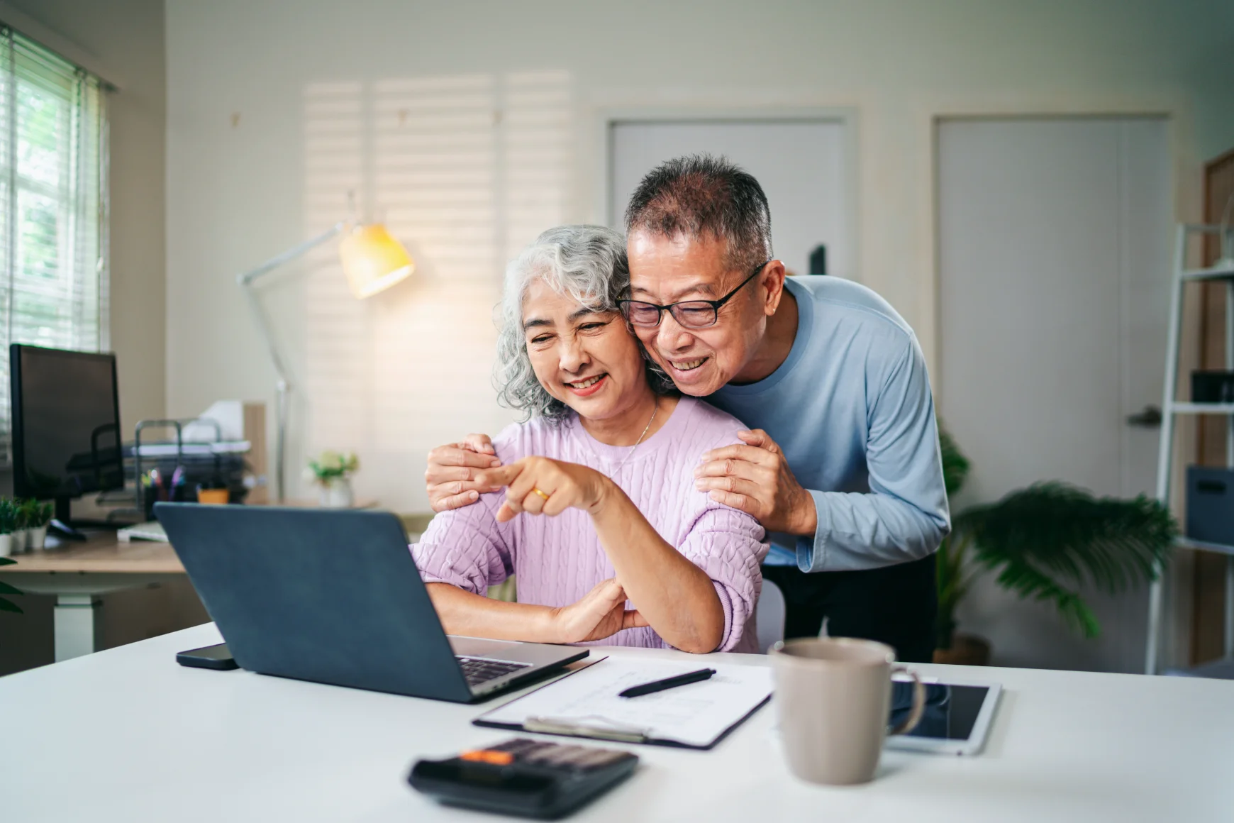 investor-researching-Canadian-investment-properties-using-laptop-and-calculator-to-evaluate-rental-income-potential-and-property-values