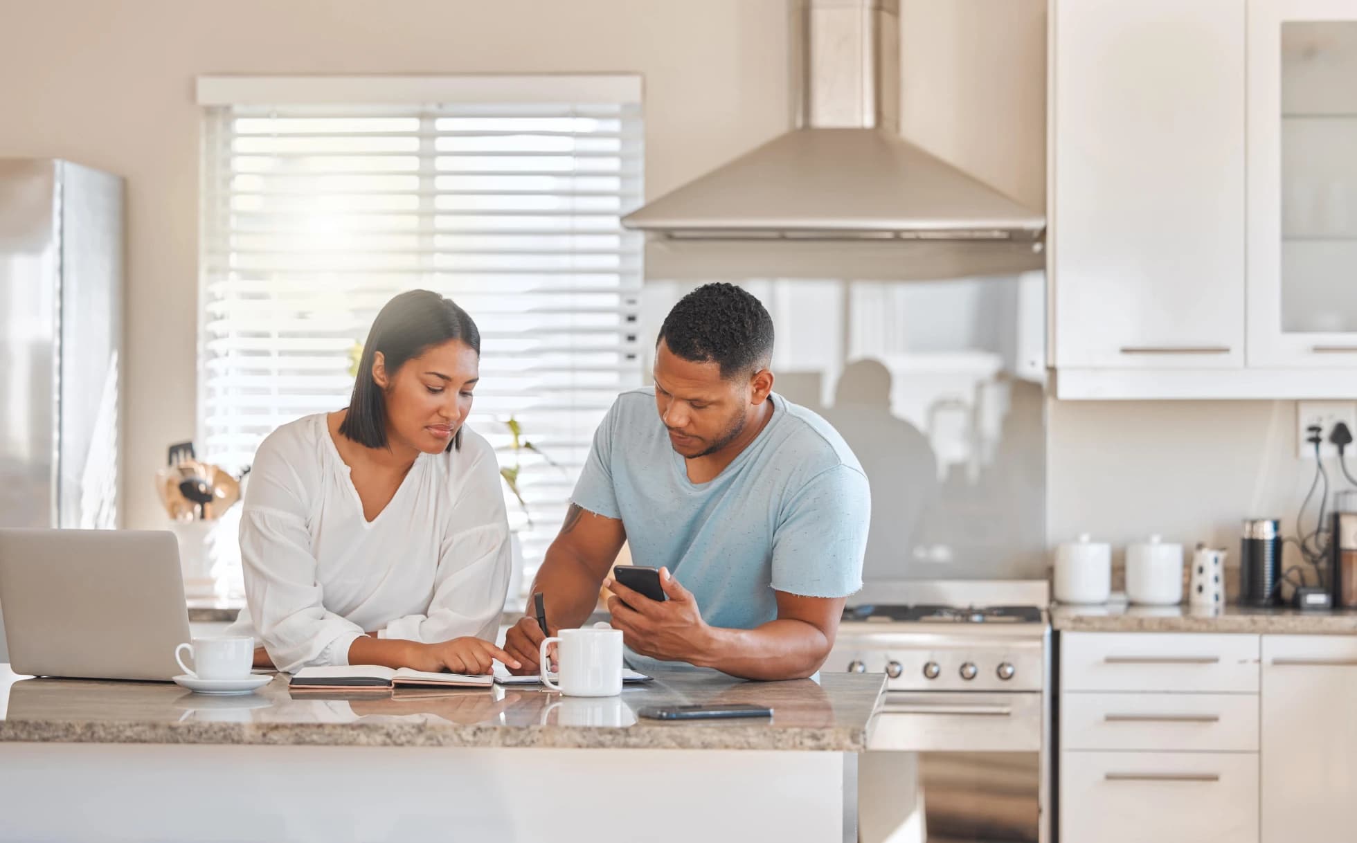 canadian-couple-looking-over-finances-on-their-laptop